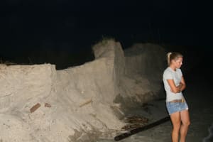 IMG_0082 Intern Chrissie turns away from the view of the Cottons over the eroded dune just north of Osprey Walk